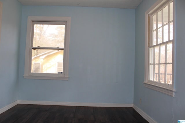 empty room with dark hardwood / wood-style floors