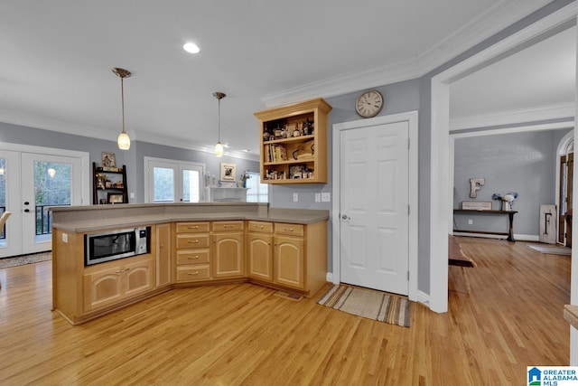 kitchen featuring light brown cabinetry, hanging light fixtures, ornamental molding, and french doors