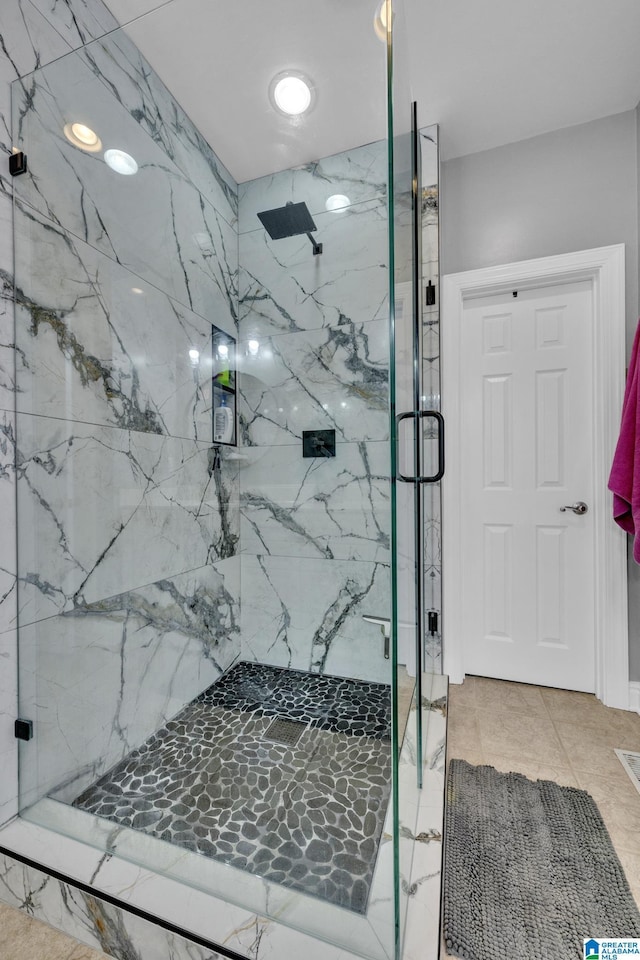 bathroom featuring a shower with shower door