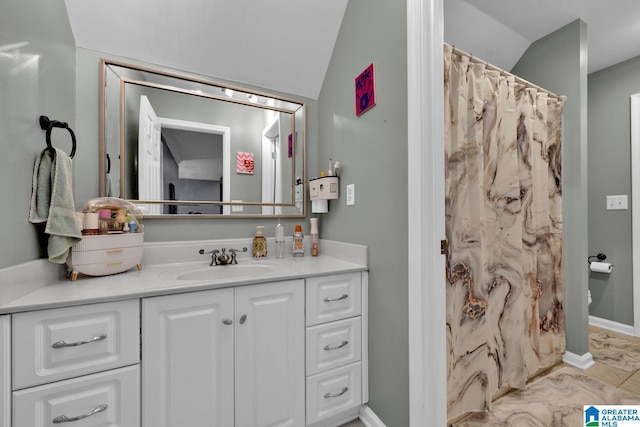 bathroom with vanity, toilet, and vaulted ceiling