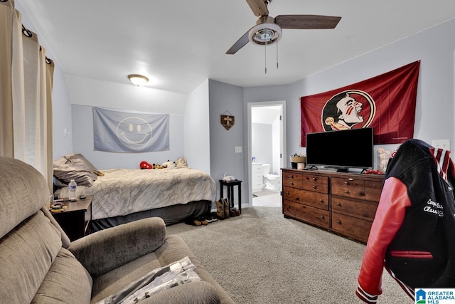 bedroom featuring ceiling fan, ensuite bathroom, and carpet