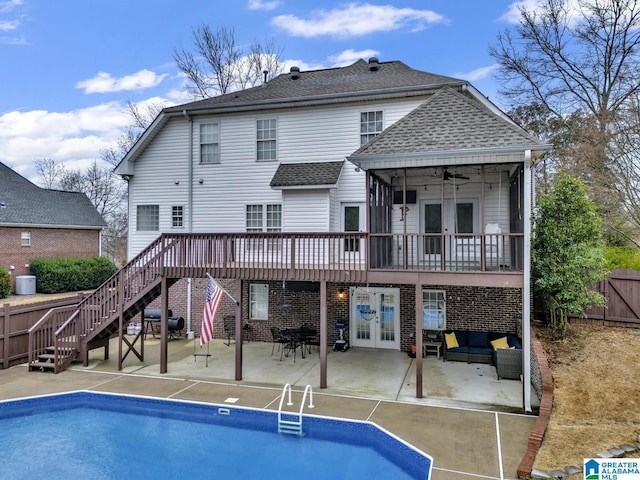 rear view of property with french doors, a patio area, ceiling fan, a swimming pool side deck, and an outdoor hangout area