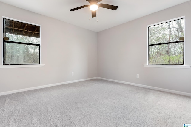 carpeted spare room with ceiling fan