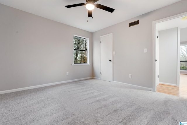 carpeted spare room with ceiling fan