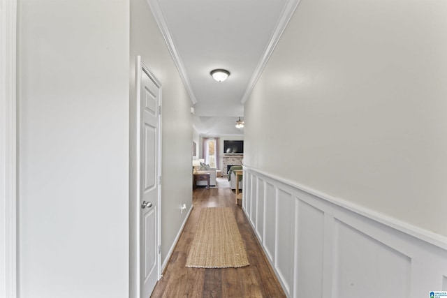 hallway featuring ornamental molding and dark hardwood / wood-style floors