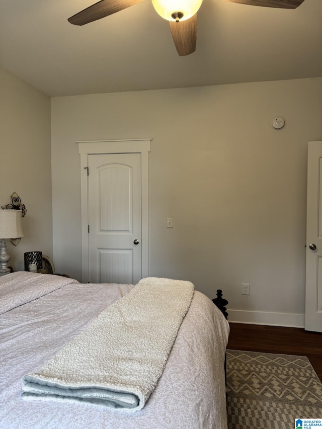 bedroom with ceiling fan and dark hardwood / wood-style flooring