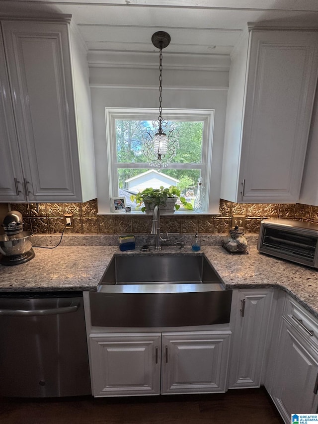 kitchen featuring a sink, stainless steel dishwasher, light stone countertops, and ornamental molding