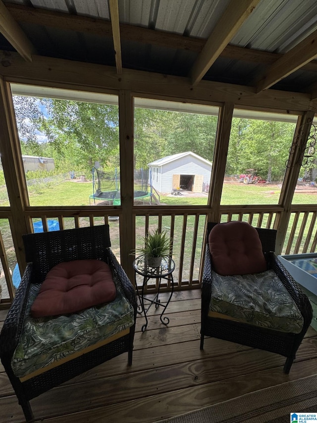 sunroom / solarium featuring a wealth of natural light and beamed ceiling