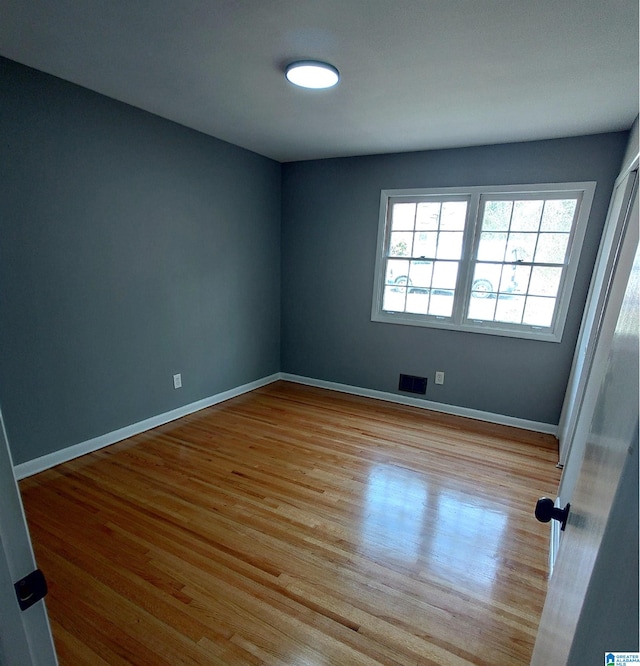 unfurnished room with light hardwood / wood-style floors