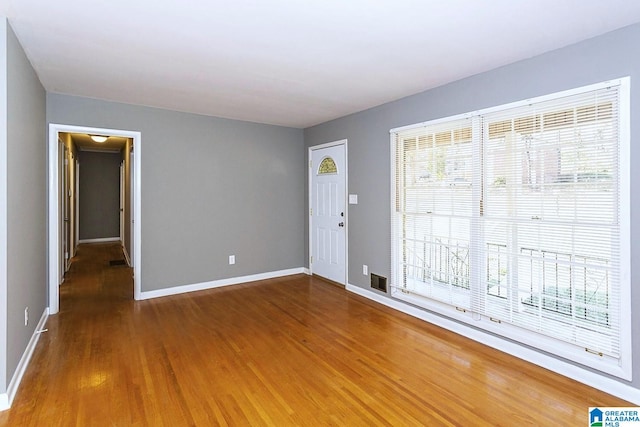 empty room with dark hardwood / wood-style floors