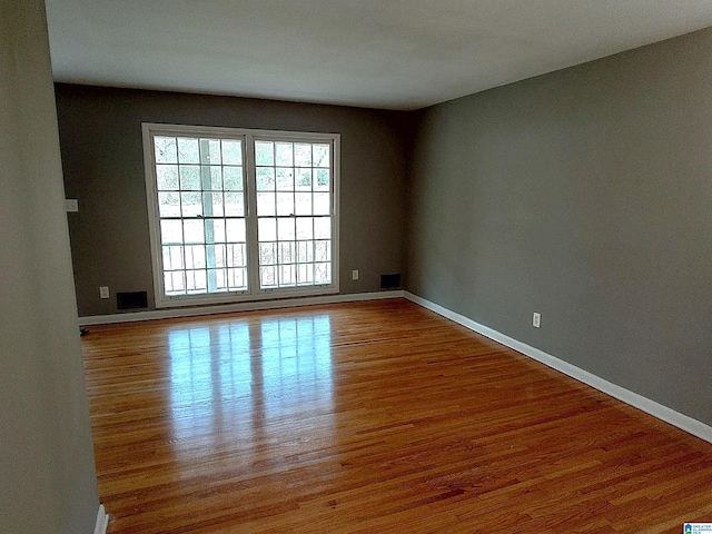 spare room with wood-type flooring