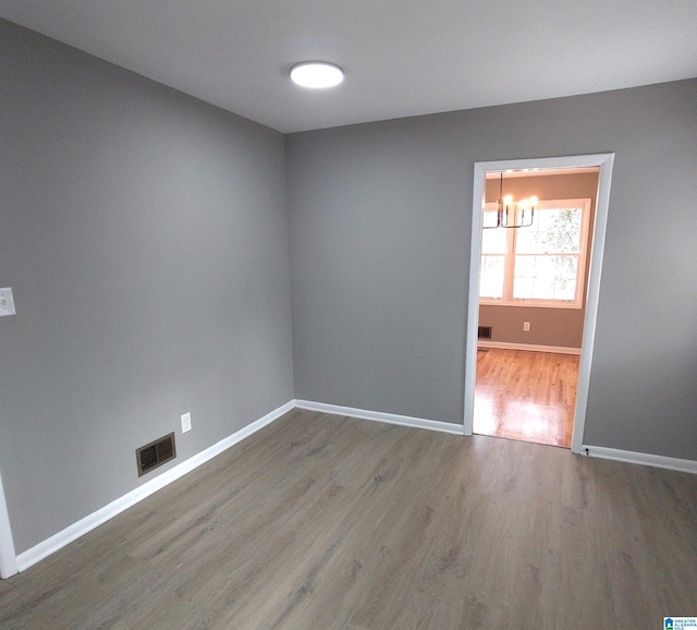 spare room with wood-type flooring