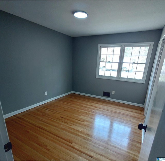 unfurnished room with light hardwood / wood-style floors