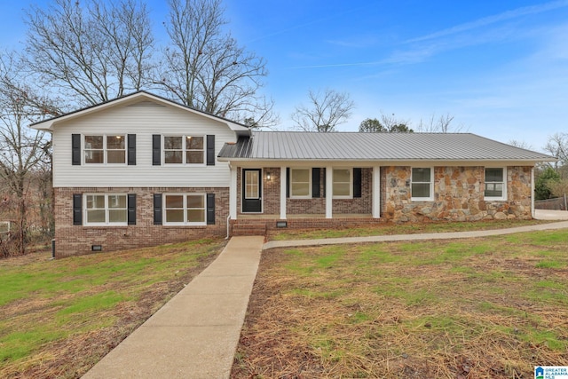 split level home featuring a porch and a front lawn