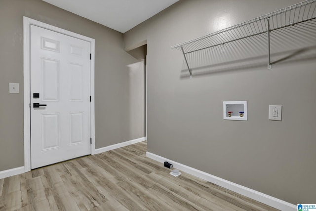 laundry room featuring washer hookup and light wood-type flooring