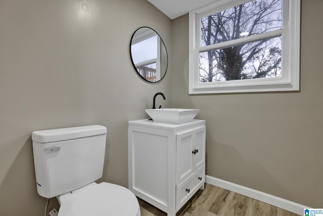 bathroom featuring vanity, toilet, and hardwood / wood-style floors