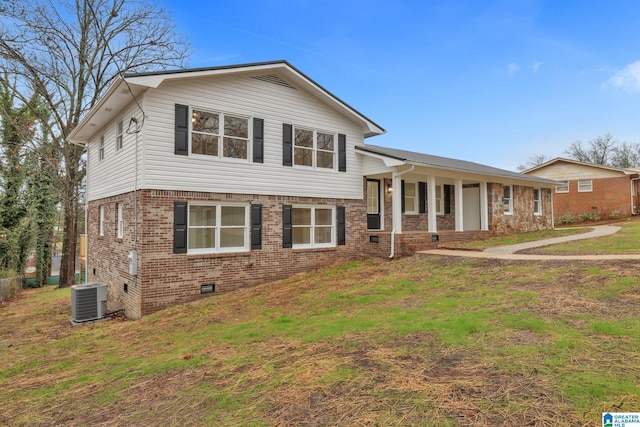 split level home featuring central AC, a front yard, and a porch