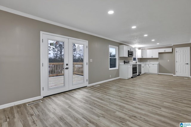 unfurnished living room featuring french doors, ornamental molding, sink, and light hardwood / wood-style flooring