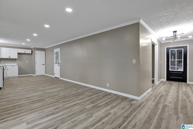 foyer featuring crown molding, a chandelier, a textured ceiling, and light wood-type flooring