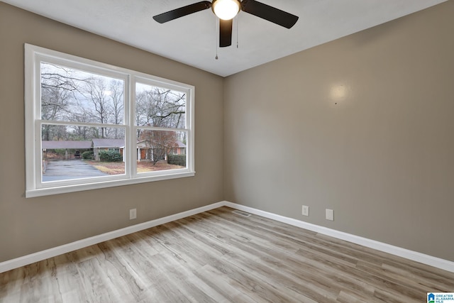 empty room featuring ceiling fan and light wood-type flooring