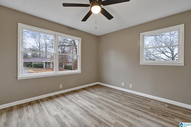 empty room featuring ceiling fan and light wood-type flooring