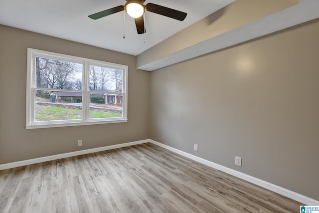 spare room with light hardwood / wood-style floors and ceiling fan