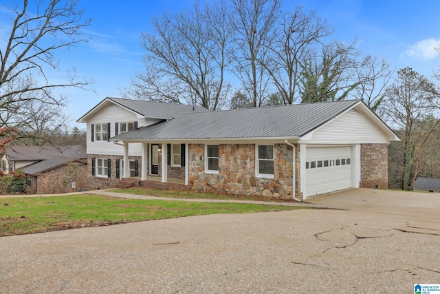 view of front of home featuring a garage, covered porch, and a front yard