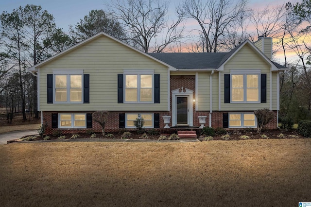 bi-level home with a lawn