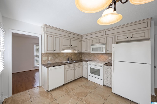 kitchen with light tile patterned flooring, sink, white appliances, and decorative backsplash