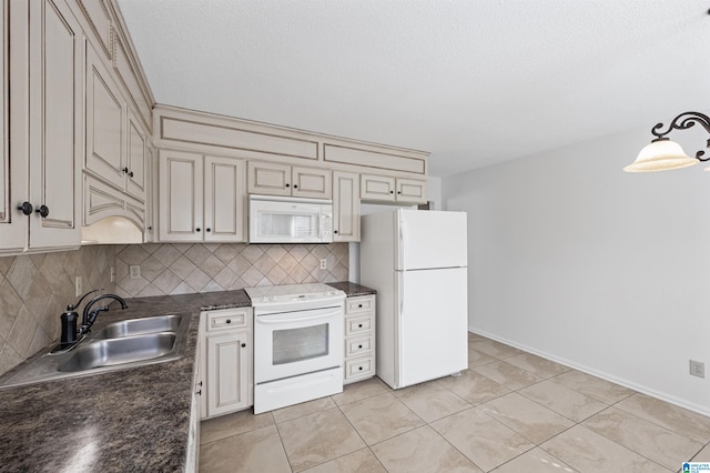 kitchen with sink, hanging light fixtures, white appliances, cream cabinets, and backsplash