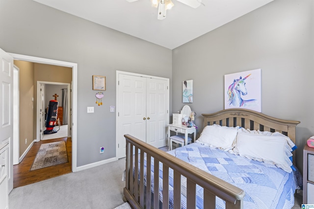 carpeted bedroom featuring ceiling fan and a closet