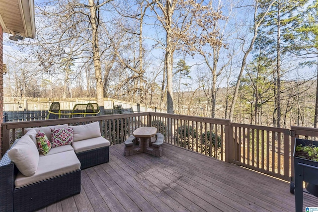 deck with outdoor lounge area and a trampoline