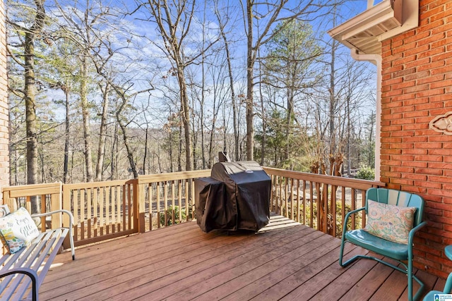 wooden terrace featuring a grill