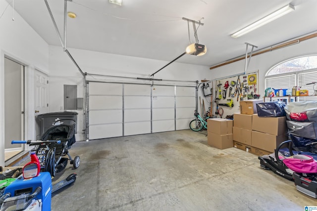 garage with a garage door opener and electric panel