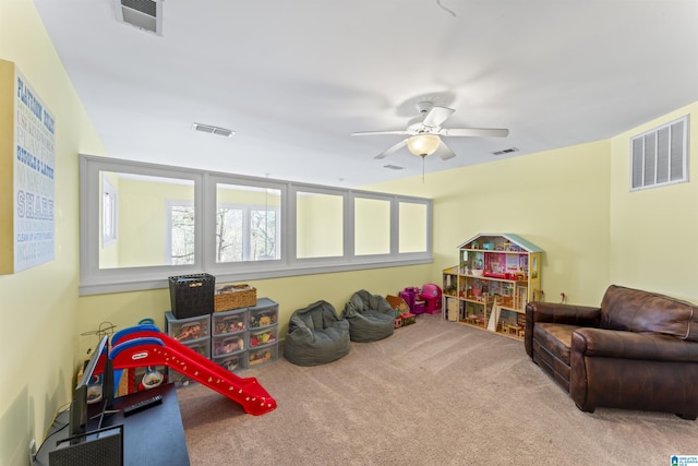 rec room with carpet flooring and ceiling fan