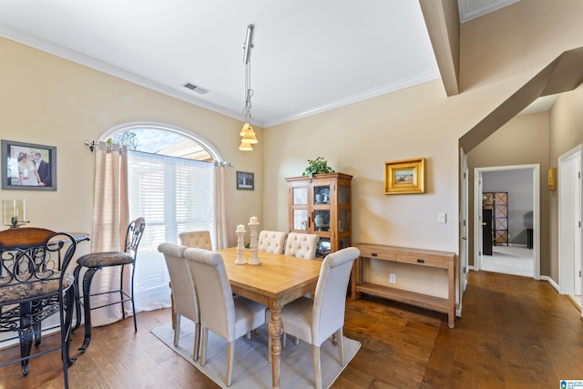 dining room with crown molding and dark wood-type flooring