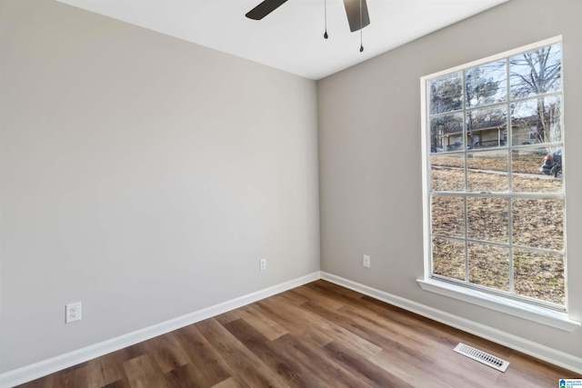 empty room with hardwood / wood-style flooring and ceiling fan