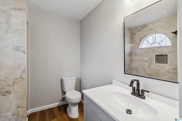 bathroom with vanity, toilet, and hardwood / wood-style floors