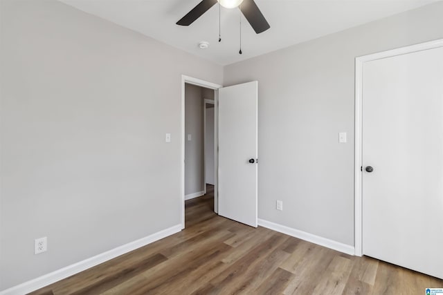 unfurnished bedroom featuring hardwood / wood-style flooring and ceiling fan