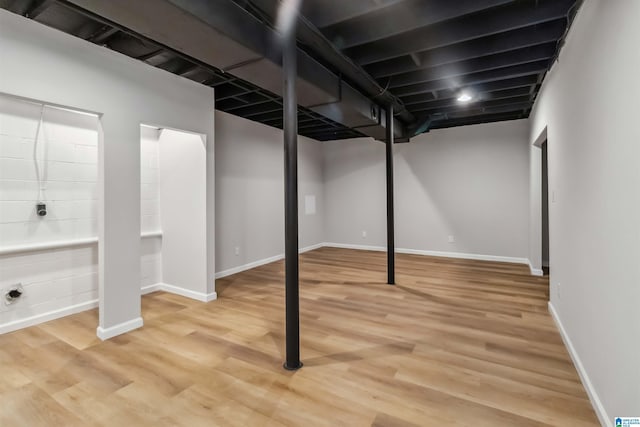 basement with hardwood / wood-style flooring