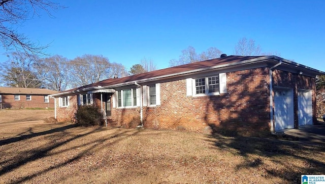 view of home's exterior featuring a garage and a lawn