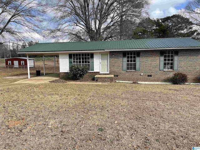 ranch-style home with a carport and a front yard