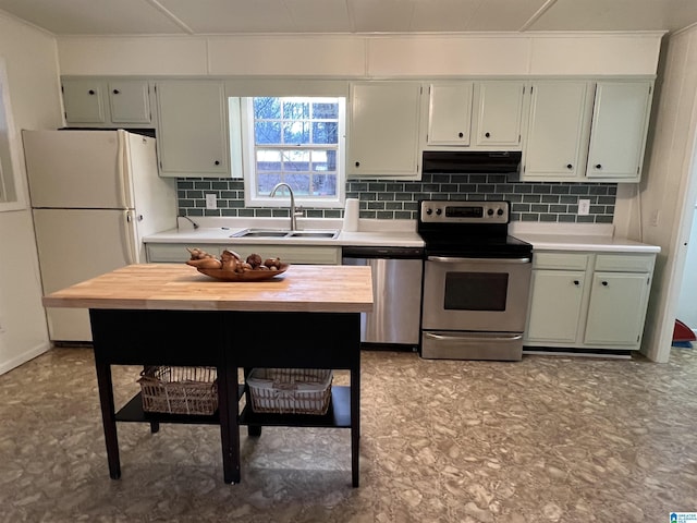 kitchen featuring tasteful backsplash, stainless steel appliances, sink, and wooden counters