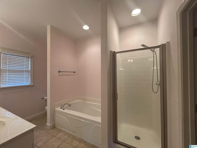 bathroom with vanity, plus walk in shower, and tile patterned flooring