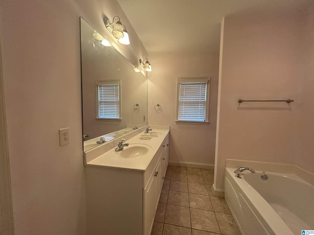 bathroom with vanity, a bath, and tile patterned floors