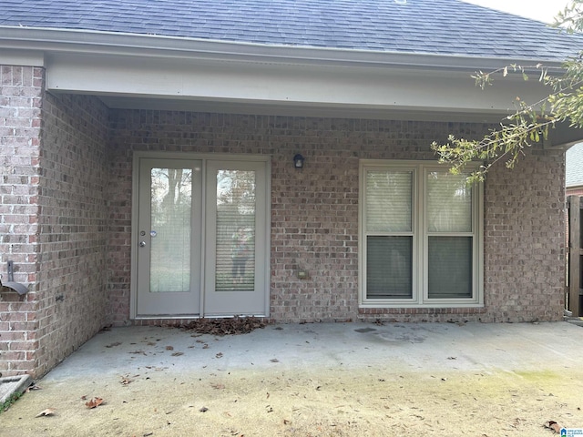 entrance to property with a patio area and french doors