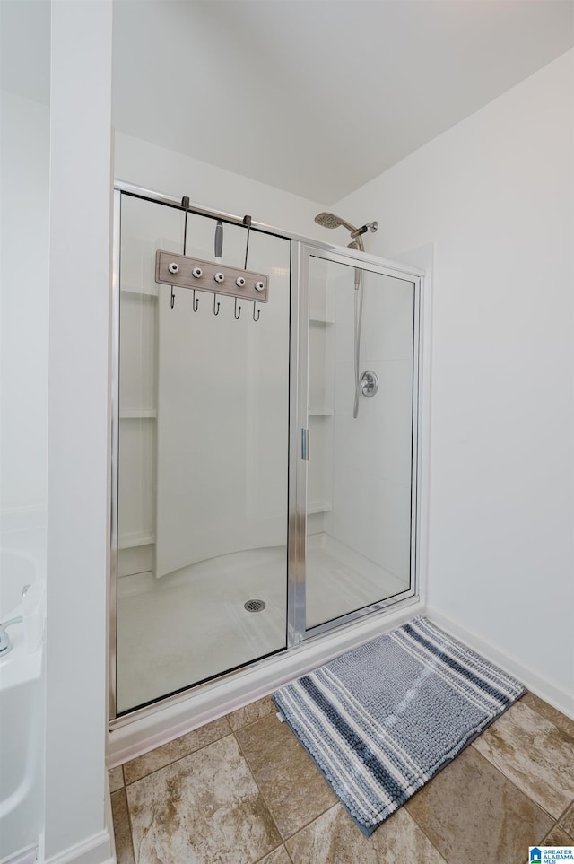 bathroom featuring a shower with door