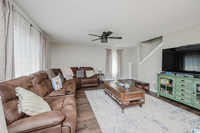 living room featuring dark wood-type flooring, a wealth of natural light, and ceiling fan