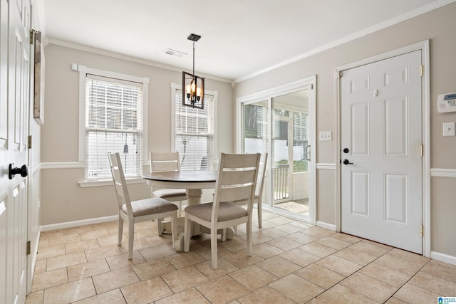 dining area with crown molding, a wealth of natural light, and a chandelier