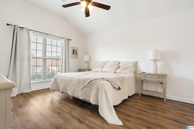 bedroom with lofted ceiling, dark hardwood / wood-style floors, and ceiling fan